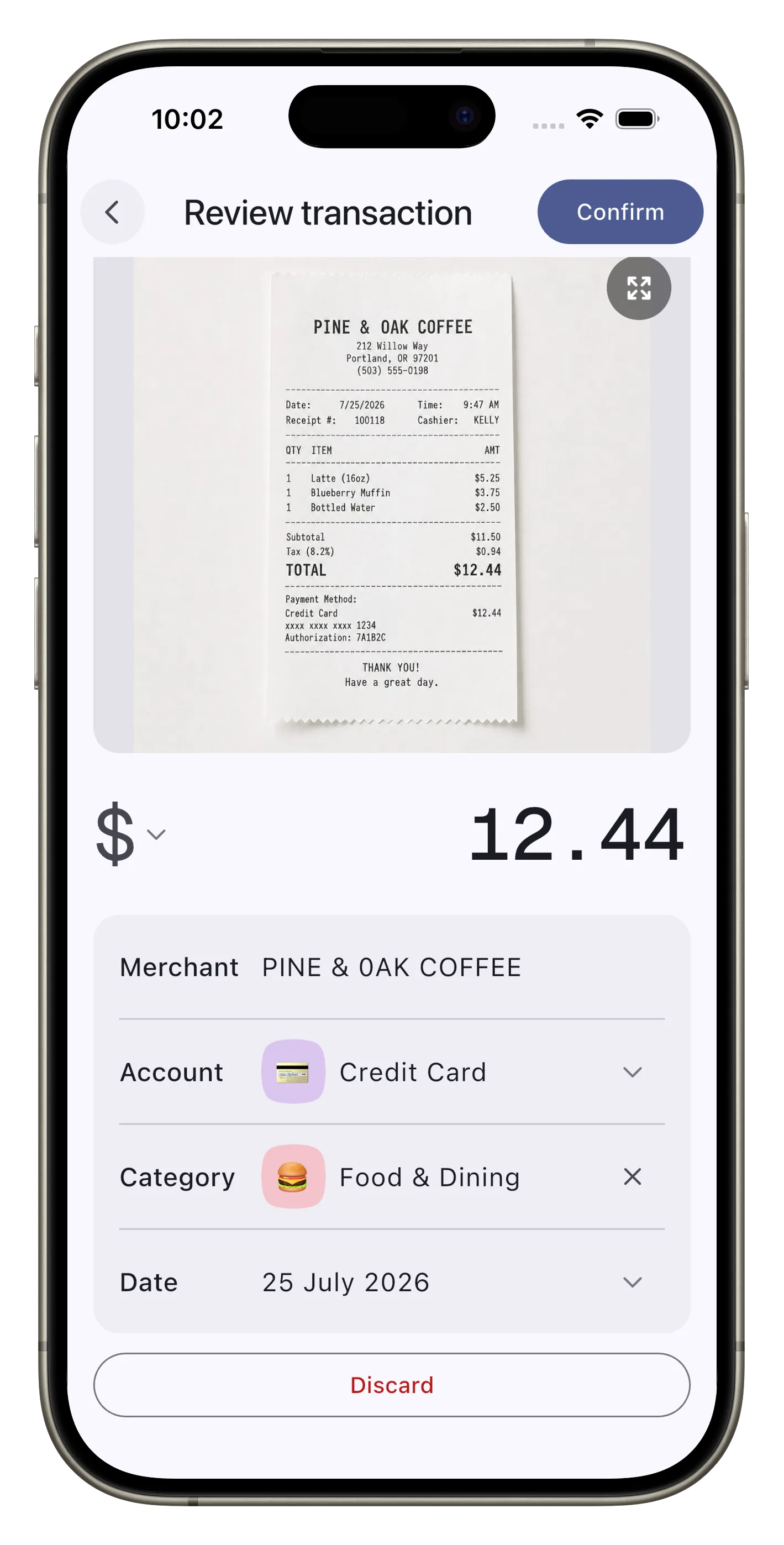 The review screen in Expensed showing the scanned receipt above a draft filled in with 12.44 dollars, the merchant, account, category, and date, waiting on Confirm or Discard.